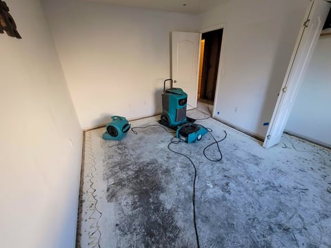 Water Damaged bedroom with air movers and dehumidifier