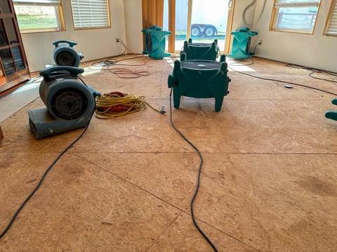 Air movers drying out a home after water damage