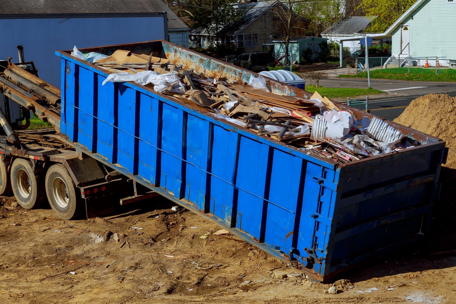 Junk removal truck loading debris